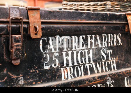 Closeup of old metal suitcase stacked on a trolley recreating a travel scene commonly seen in the 1940s, 1950s and 1960s Stock Photo