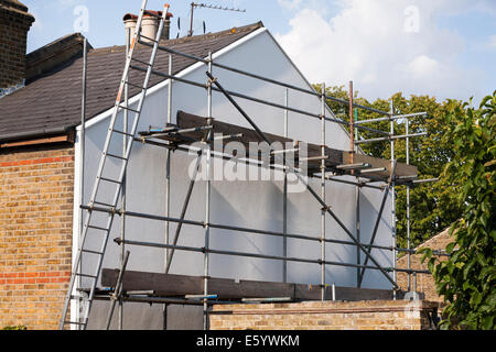 Rigid foam wall insulation and scaffolding on a Victorian terraced house gable end UK Stock Photo