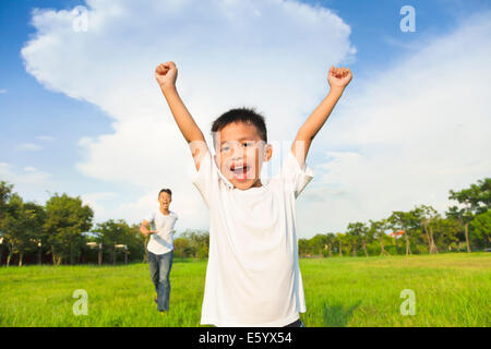 happy father and son playing in meadow Stock Photo