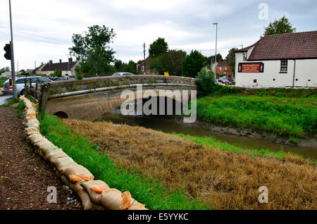 Burrowbridge, Somerset, UK. 9th August, 2014. UK weather:  An Emergency call out for local helpers to make more Sandbags to be put in place around the bridge and along the Main Road opposite due to very bad weather forecast moving in. Credit:  Robert Timoney/Alamy Live News