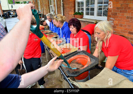 Burrowbridge, Somerset, UK. 9th August, 2014. UK weather:  An Emergency call out for local helpers to make more sandbags to be put in place around the bridge and along the Main Road opposite due to very bad weather forecast moving in Credit:  Robert Timoney/Alamy Live News