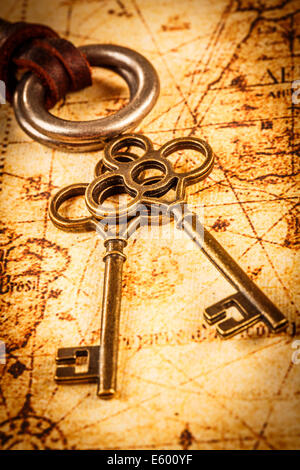 Old scrolls on brown paper background - Old Keys On An Ancient World Map E600yf 