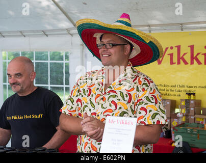 West Dean, Chichester, UK. 9th August, 2014. Mr Vikki talks to the crowd of visitors at his stall during the Chilli Fiesta at West Dean, August 2014. UK weather.  Credit:  MeonStock/Alamy Live News Stock Photo