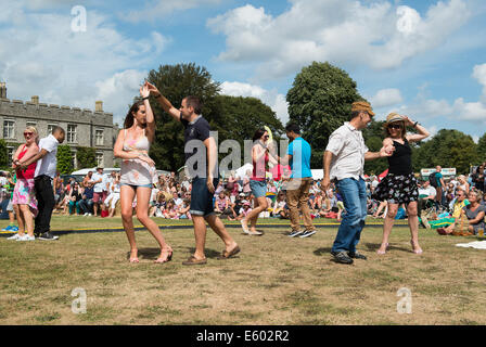 West Dean, Chichester, UK. 9th August, 2014. Salsa dancers take advantage of the music and a warm and sunny summers day at the Chilli Fiesta in West Dean, August 2014. UK weather.  Credit:  MeonStock/Alamy Live News Stock Photo