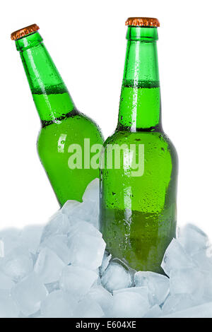 Two bottles of beer on ice. Isolated on white background. Stock Photo