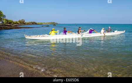 Paddlers in outrigger canoe at Anaehoomalu Bay on the Big Island of Hawaii Stock Photo