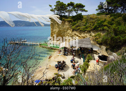 Zante, Greece - Agios Sostis resort with private island hosting bar and beach music club. Beach club with day and night DJ party Stock Photo