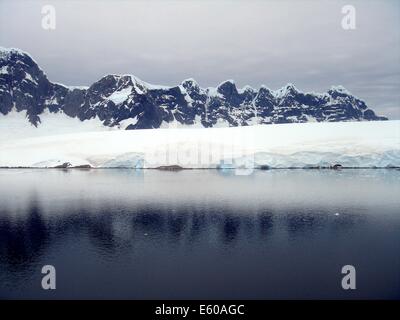 Snow, rock and ice reflections at sunset on the Antarctic Peninsula Stock Photo