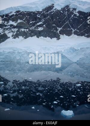 Snow, rock and ice reflections at sunset on the Antarctic Peninsula Stock Photo