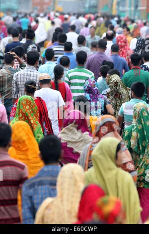 Garment workers are in a long queue to join their workplace in Ashulia in Dhaka on August 9, 2014 Stock Photo