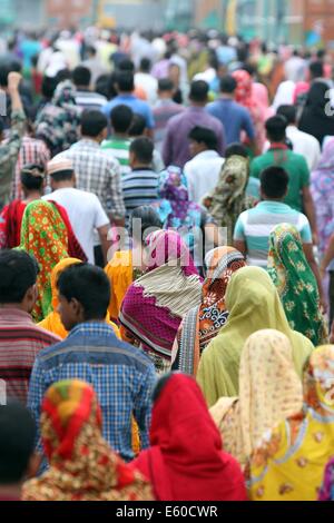 Garment workers are in a long queue to join their workplace in Ashulia in Dhaka on August 9, 2014 Stock Photo