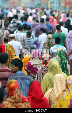 Garment workers are in a long queue to join their workplace in Ashulia in Dhaka on August 9, 2014 Stock Photo