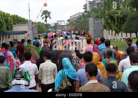 Garment workers are in a long queue to join their workplace in Ashulia in Dhaka on August 9, 2014 Stock Photo