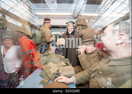 Waterloo Station, London, UK. 10th August 2014. The Khaki Chums, a regiment of living historians, re-enacted the journey of WW1 soldiers arriving at Waterloo Station in London, sleeping on railway land overnight before departing on a train bound for Southampton. The regiment performed a march through the station to pay their respects to those who stood in their shoes a century ago. The re-enactment was part of the launch of an exhibition detailing the vital role Britain's railways and staff played in the Great War. Credit:  Lee Thomas/Alamy Live News Stock Photo