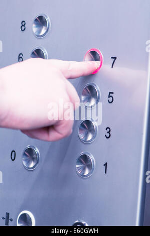 white man pushing buttons on an elevator Stock Photo