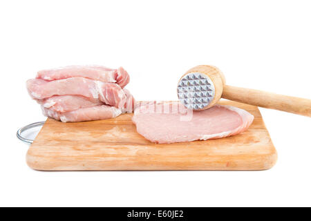 raw meat and meat tenderizer on board - white background Stock Photo