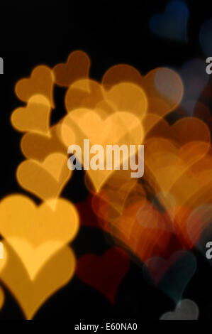 Colorful hearts blurry lights at night. Valentine's day abstract background. Stock Photo