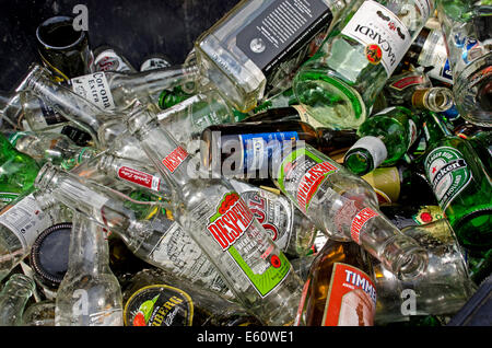 Empty beer and spirit bottles in a bin outside a public house waiting to be taken away to be recycled. Stock Photo