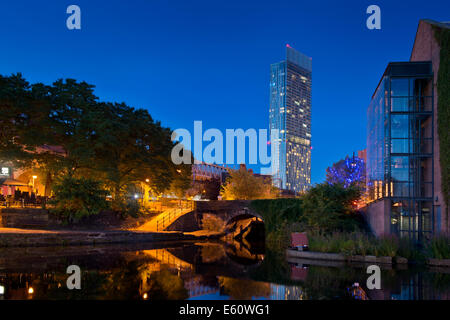 The Castlefield Urban Heritage Park and historic inner city canal conservation area with Beetham Tower in Manchester at night. Stock Photo