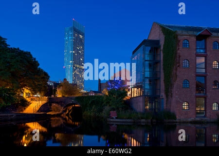 The Castlefield Urban Heritage Park and historic inner city canal conservation area with Beetham Tower in Manchester at night. Stock Photo