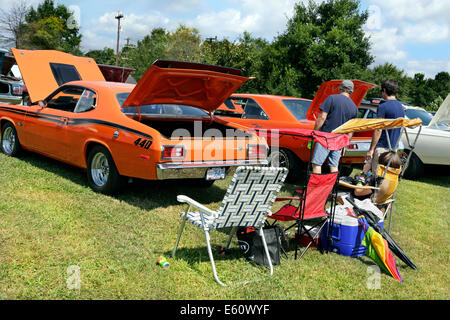 American vintage car show in Salisbury, North Carolina. Family picnic behind a1973 Plymouth Duster. Stock Photo