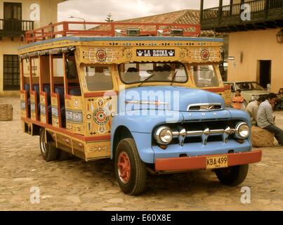 A typical elaborately painted Colombian Chiva bus, in the central plaza, Villa de Leyva, Boyaca department, Colombia. Stock Photo