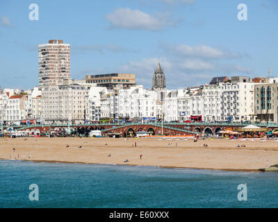 South coast seaside landscape: view of Brighton skyline, seafront, promenade and beach on a sunny summer day with a blue sky and sea Stock Photo