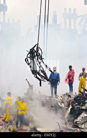 Rescue workers use cranes to clear twisted metal from the pile of rubble amongst the wreckage of the World Trade Center in the aftermath of a massive terrorist attack which destroyed the twin towers killing 2,606 people September 20, 2001 in New York, NY. Stock Photo