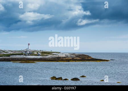 Image of Peggy's Point Lighthouse on a stormy day with dramatic clouds above the lighthouse. Stock Photo