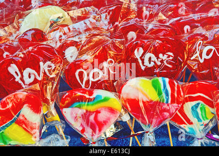 Colorful sweets, candies and lollipops with word love at street market Stock Photo
