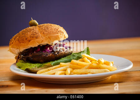 Multigrain bun vegan Portobello Burger plate with fries Stock Photo