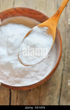 Close-up of Spoon of baking soda over bowl of baking soda Stock Photo