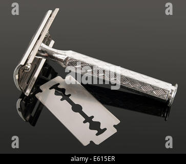 vintage razor and blade with reflection isolated on gray background Stock Photo