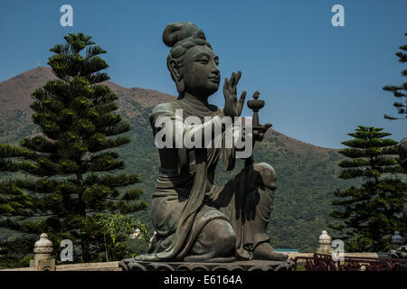 Buddhist statue praising Tian Tan Buddha or the Big Buddha, Lantau Island, Hong Kong, China Stock Photo