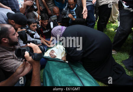 A Palestinian man mourns next to the body of his child who was killed ...