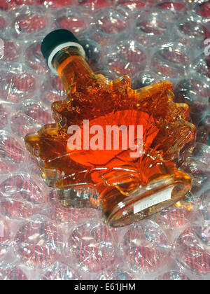 A Canadian maple syrup bottle in the shape of a maple leaf. Stock Photo