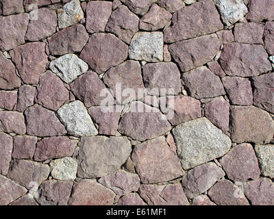 Stone Wall - Dry Set Masonry - Interlocking natural stones are forming a stone wall. Stock Photo