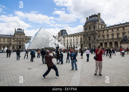 Tourists and visitors outside Louvre Museum in Paris, France Stock Photo