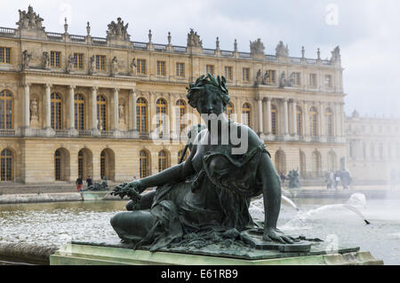 Sculptures and statues in the Gardens of Versailles with the Palace of Versailles in the background, France Stock Photo