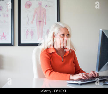 Doctor working on computer Stock Photo