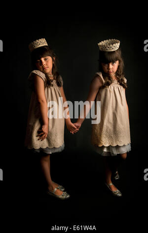 Two girls (6-7) in lace crowns Stock Photo