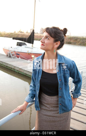 Woman standing on jetty Stock Photo
