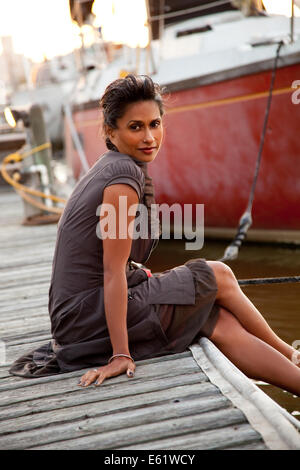 Portrait of woman standing on jetty Stock Photo