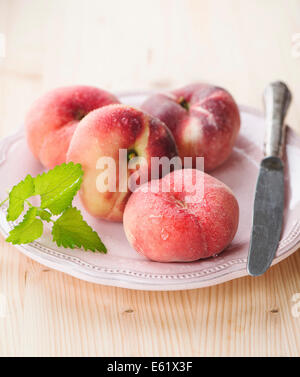 Ripe juicy chinese flat peaches (also called Saturn peaches) Stock Photo