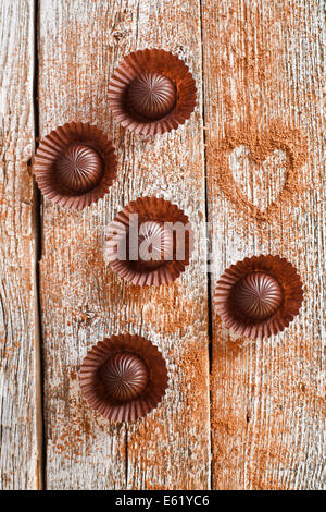 Milk and dark chocolate. Sweet gift. Chocolate sweets. Foot. Butterfly. A  bar of dark chocolate on an orange background Stock Photo - Alamy