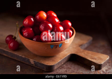 Fresh ripe cherries in a bowl on dark background Stock Photo