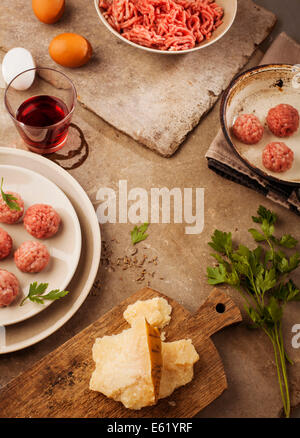 Meatballs cooking with mince, parsley, parmesan, wine and eggs. Stock Photo