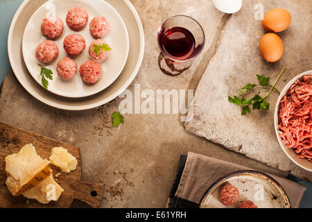 Meatballs cooking with mince, parsley, parmesan, wine and eggs. Stock Photo