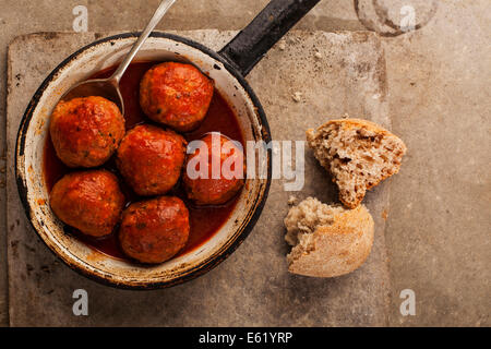 Meatballs cooked in tomato sauce in pan on grey backround Stock Photo