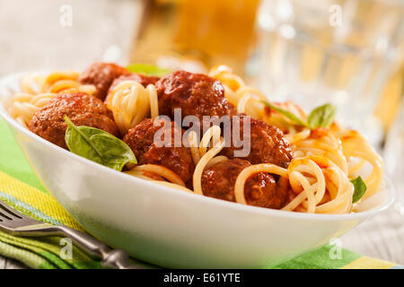 Pasta with meatballs with fresh basil and tomato sauce Stock Photo